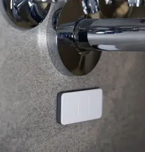 Quensus Splash Sensor located under a wall-mounted sink
