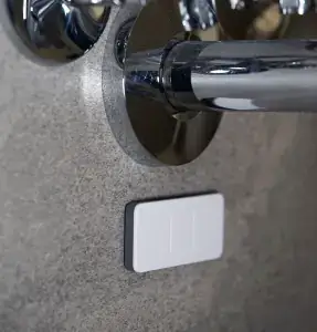 Quensus Splash Sensor located under a wall-mounted sink